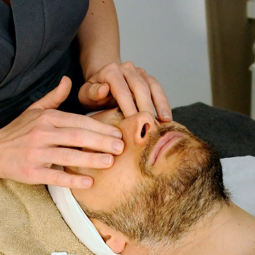 sleeping man while having massage